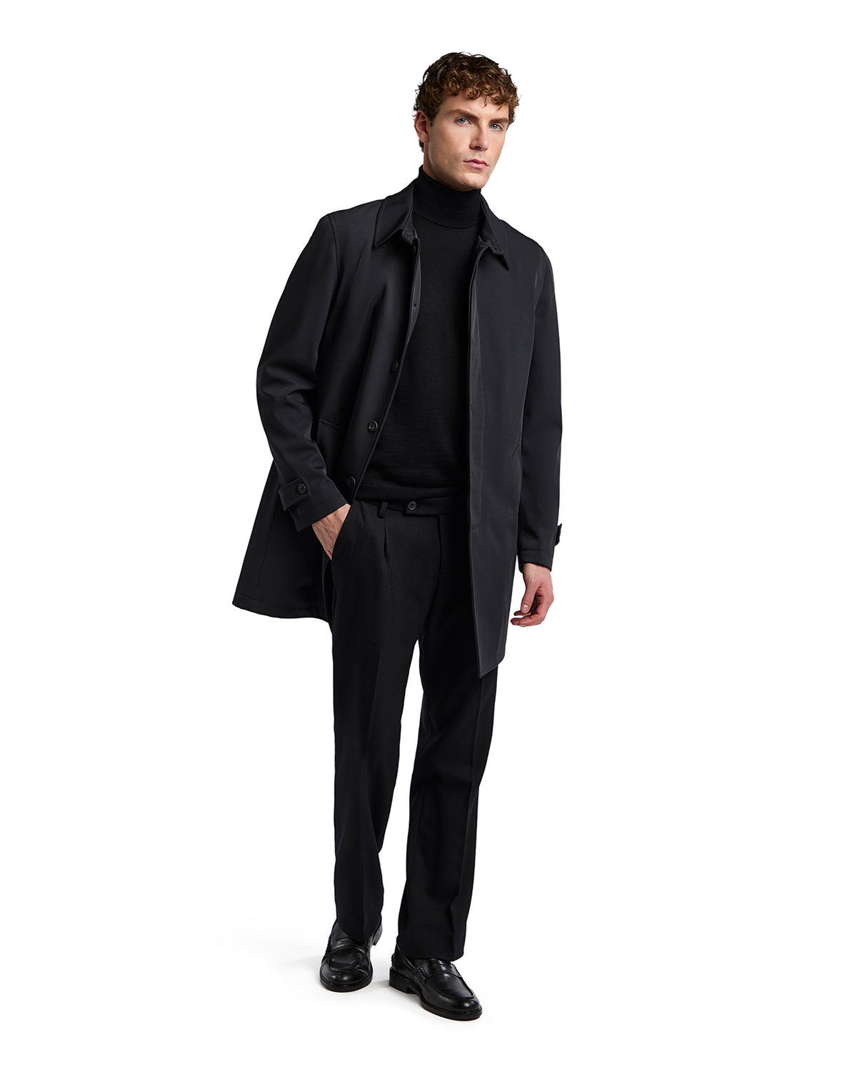 Men's black coat with a tailored fit, paired with a black turtleneck and trousers, showcasing a sleek, modern style.